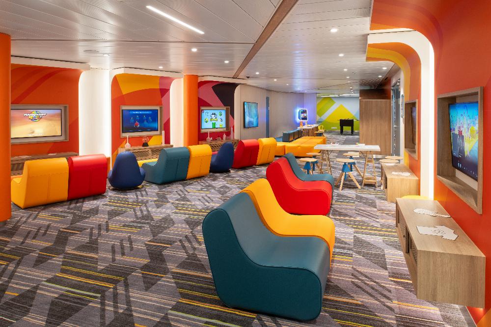 Teen lounge with gaming screens, air hockey and colourful modular seating