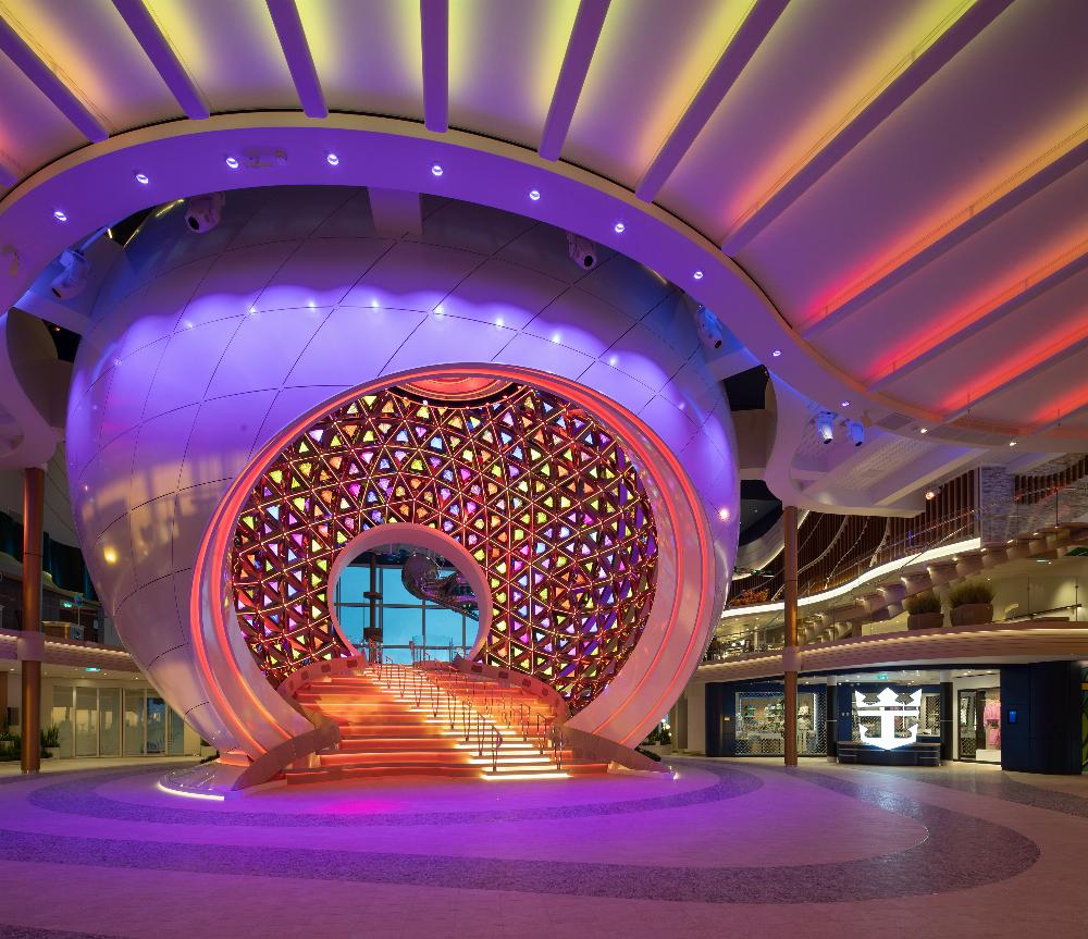 The Pearl kinetic sculpture glowing pink and gold in the Royal Promenade