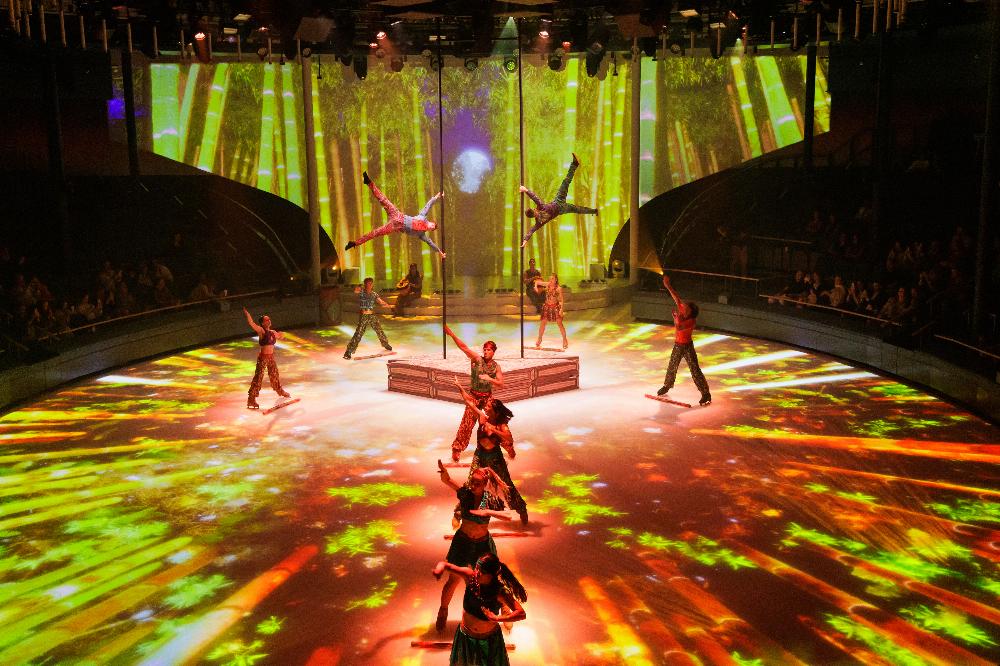 Ice skaters and aerialists performing in a bamboo-themed ice show
